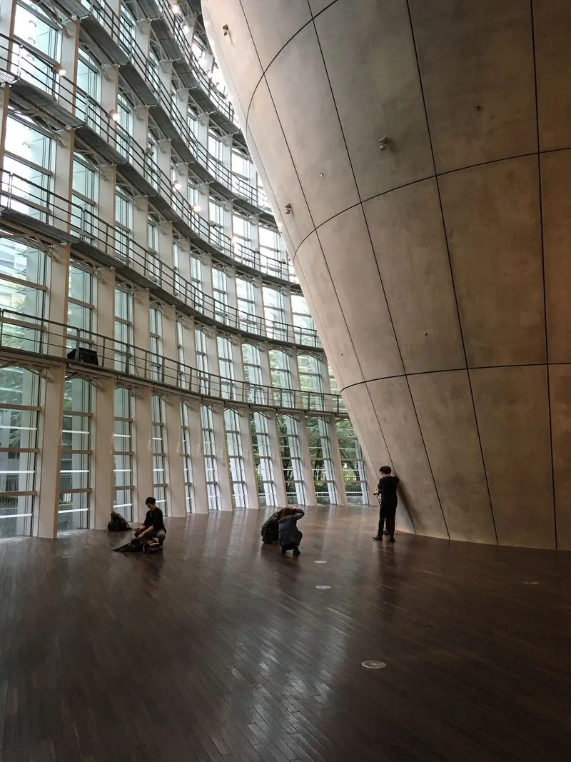 Undulating glass wall and concrete cone inside the National Art Center, Tokyo